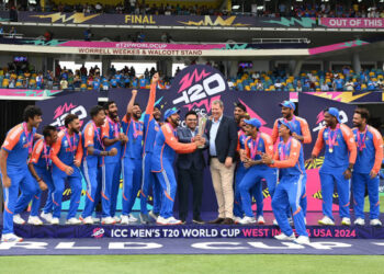 BRIDGETOWN, BARBADOS - JUNE 29: Rohit Sharma of India receives the trophy from Jay Shah of the BCCI and Greg Barclay of the ICC after India won the ICC Men's T20 Cricket World Cup West Indies & USA 2024 Final match between South Africa and India at Kensington Oval on June 29, 2024 in Bridgetown, Barbados. (Photo by Philip Brown/Getty Images)