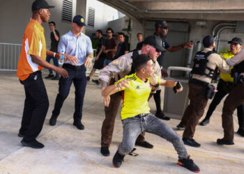 MIAMI GARDENS, FLORIDA - JULY 14: Police officers try to arrest a Colombian fan outside the stadium the CONMEBOL Copa America 2024 Final match between Argentina and Colombia at Hard Rock Stadium on July 14, 2024 in Miami Gardens, Florida. (Photo by Maddie Meyer/Getty Images)