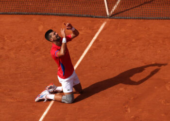 PARIS, FRANCE - AUGUST 04: Novak Djokovic of Team Serbia celebrates match point during the Men's Singles Gold medal match against Carlos Alcaraz of Team Spain on day nine of the Olympic Games Paris 2024 at Roland Garros on August 04, 2024 in Paris, France. (Photo by Matthew Stockman/Getty Images)